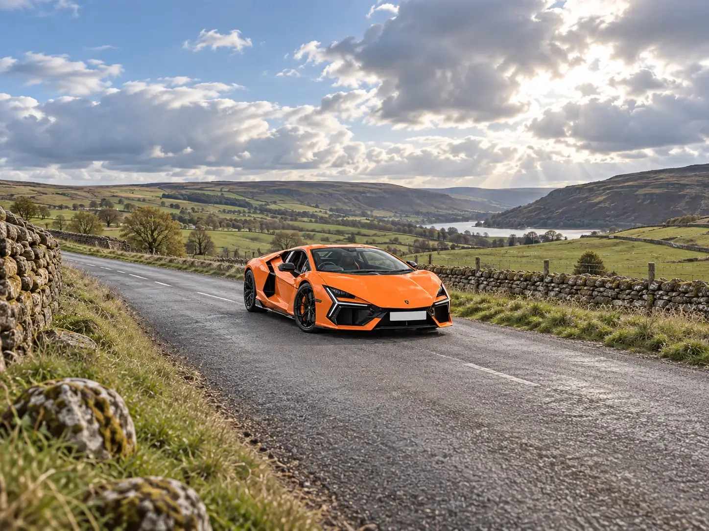 Orange Lamborghini Revuelto on a quiet Peak District countryside road